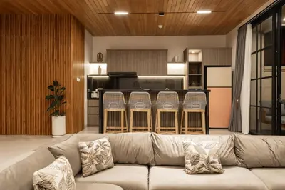 a living room with a couch and a kitchen at Ben's Villa 1 by Alfred in Bali in Kerobokan