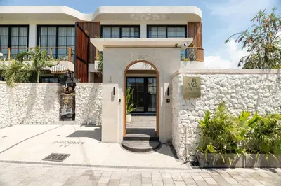 a house with a stone wall and a door at Ben's Villa 2 by Alfred in Bali in Kerobokan