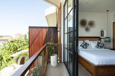 a bedroom with a bed on a balcony at Ben's Villa 2 by Alfred in Bali in Kerobokan