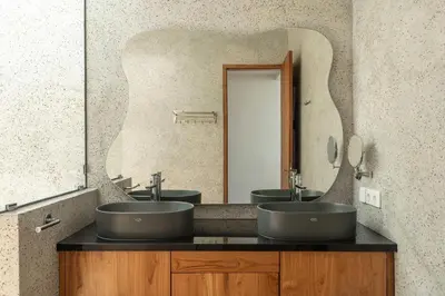 a bathroom with two sinks and a large mirror at Ben's Villa 2 by Alfred in Bali in Kerobokan