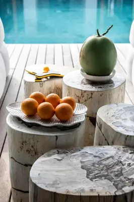 a plate of oranges and an apple on a table at Villa Gendang in Seminyak