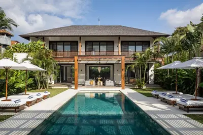 a villa with a swimming pool and a house at Villa Gendang in Seminyak