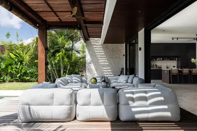 a group of white chairs sitting on a patio at Villa Gendang in Seminyak