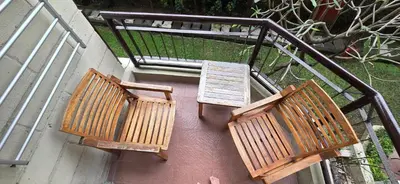 three wooden benches sitting on top of a building at The Palmana Tropical Courtyard Jayakarta Residence 12 in Seminyak