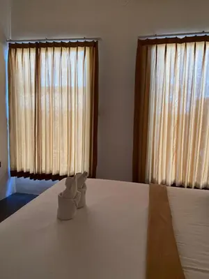 a bedroom with a bed with two white towels on it at Kubu Jimbaran in Jimbaran