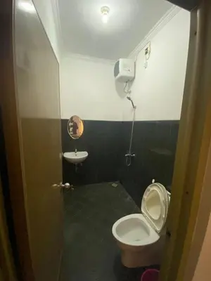 a small bathroom with a toilet and a sink at Kubu Jimbaran in Jimbaran