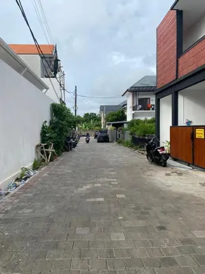 an empty street with motorcycles parked on the side of a building at Kubu Jimbaran in Jimbaran