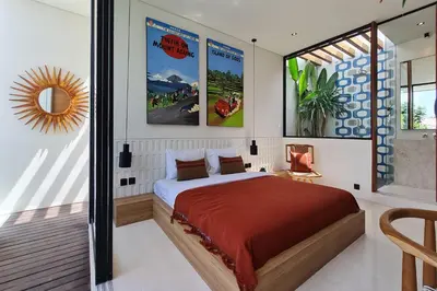 a bedroom with a large bed with posters on the wall at Casa Ipanema, Luxury 2 Bedrooms Villa with Cinema in Private Quiet Area in Canggu