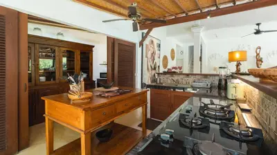 a kitchen with a counter and a stove in it at Villa Mogi by Villa Finder in Seminyak