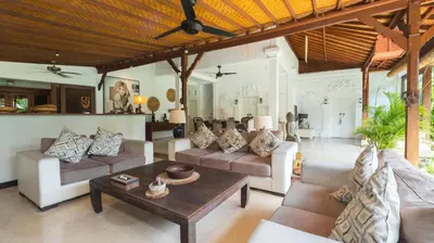 a living room with couches and a table at Villa Mogi by Villa Finder in Seminyak
