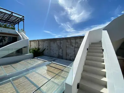 a staircase leading up to a house with a glass roof at Anjou - Twin Villa in Berawa Canggu in Canggu