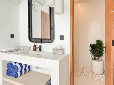 a bathroom with a sink and a mirror at Burgundy - Twin Villa in Berawa Canggu in Canggu