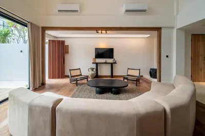a living room with a large couch and a table at Stylish 4 bedroom Villa in Prime Location in Canggu