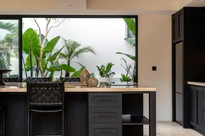 a kitchen with a large window with plants in it at Stylish 4 bedroom Villa in Prime Location in Canggu