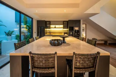 an open kitchen and dining room with a large table and chairs at Stylish 4 bedroom Villa in Prime Location in Canggu