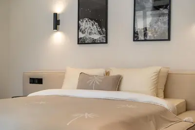 a bedroom with a bed with three pictures on the wall at Stylish 4 bedroom Villa in Prime Location in Canggu