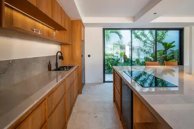 a kitchen with a large counter and a large window at Stylish 2 bedroom Villa in Prime Location in Canggu