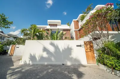 a white fence with a gate in front of a house at Stylish 2 bedroom Villa in Prime Location in Canggu