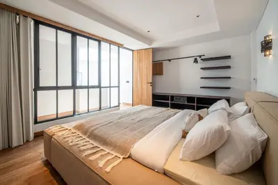 a large bedroom with a large bed and large windows at Stylish 2 bedroom Villa in Prime Location in Canggu