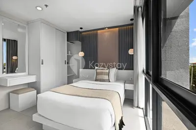 a small bedroom with a bed and a window at Alva by Kozystay - Nusa Dua in Nusa Dua