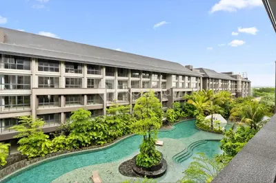 an apartment building with a pool in front of it at Alva by Kozystay - Nusa Dua in Nusa Dua