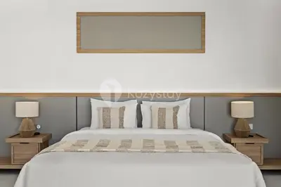 a bedroom with a white bed and two lamps at Navaya Villa by Kozystay - Seminyak in Seminyak