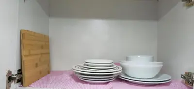a stack of plates and bowls sitting on a shelf at The Palmana Tropical Garden Jayakarta Residence 38 in Seminyak