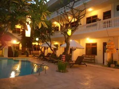 a hotel with a swimming pool in front of a building at W Hotel at Kuta Beach By Micky Studio -1 minutes to beach in Legian