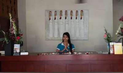 a woman sitting at a counter in a salon at W Hotel at Kuta Beach By Micky Studio -1 minutes to beach in Legian