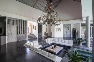 a living room with a couch and a chandelier at House of Winds Complex - Stylish 12BR Design Estate - 4 Villas near Canggu in Kerobokan