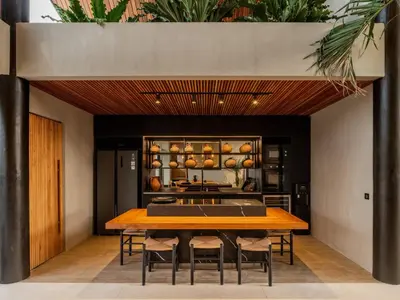 a dining room with a table and chairs at House of Winds Complex - Stylish 12BR Design Estate - 4 Villas near Canggu in Kerobokan