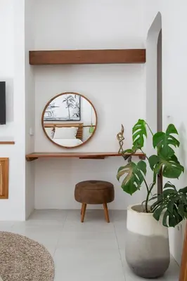 a mirror and a plant in a room at Villa Mai Mai Seminyak in Seminyak