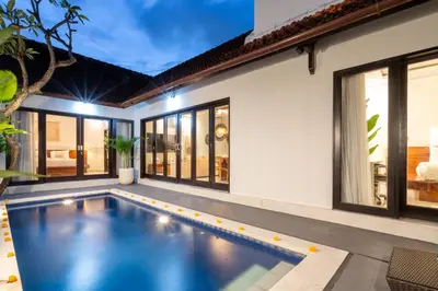 an indoor swimming pool in the backyard of a house at Villa Kunti in Seminyak