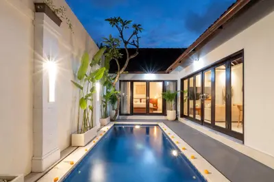 an indoor swimming pool in a house at Villa Kunti in Seminyak