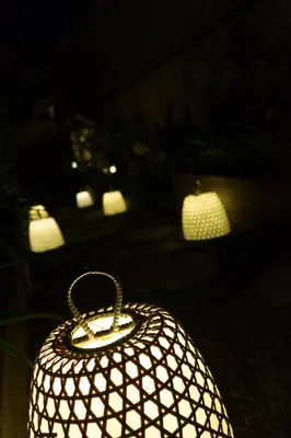 a lit up lantern with lights in the background at The Secret Villas in Seminyak
