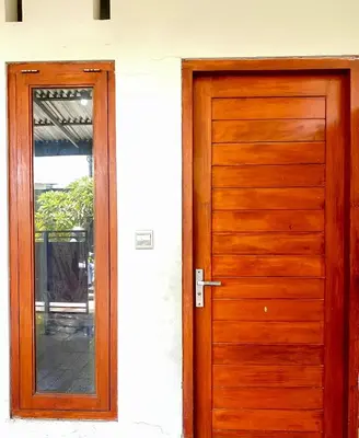 a wooden door in front of a house at Room in Guest House near Kuta Beach Bali in Pesanggaran