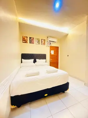 a bedroom with a large bed in a room at Room in Guest House near Kuta Beach Bali in Pesanggaran