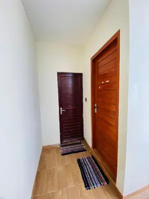 a room with a wooden door and a wooden floor at Room in Guest House near Kuta Beach Bali in Pesanggaran