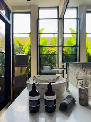 a bathroom with a sink and a mirror at Villa Nelaya - Modern 3BR Retreat Private Pool Walk to the Beach in Seminyak