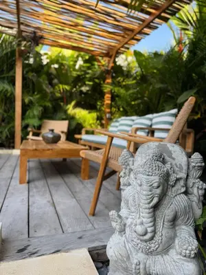 a statue of an elephant sitting on a patio at Villa Nelaya - Modern 3BR Retreat Private Pool Walk to the Beach in Seminyak