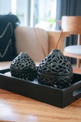 two black vases on a black plate on a table at NEW! Queen Villa - 2BR Villa in Seminyak in Seminyak