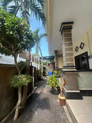 a courtyard with trees and plants in a building at OSA Guest House 3 in Seminyak