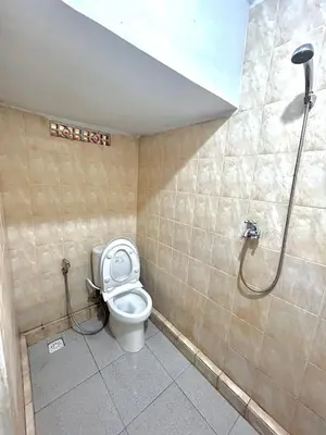 a bathroom with a toilet and a shower at OSA Guest House 3 in Seminyak