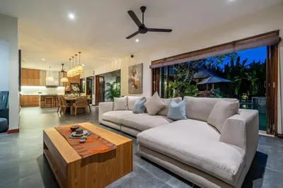 a living room with a couch and a table at Villa Bettini Stylish 3BR with Pool Near Bintang in Seminyak