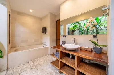 a bathroom with a sink and a tub at Villa Bettini Stylish 3BR with Pool Near Bintang in Seminyak