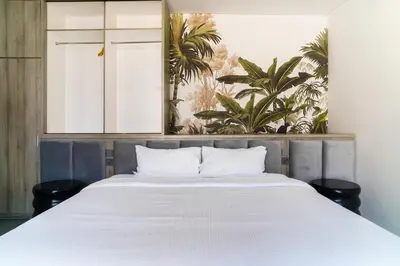a bedroom with a large bed with white sheets at New 3 Bedroom Villa with rooftop central Seminyak in Seminyak