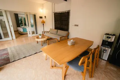 a living room with a wooden table and a couch at Villa Nagomi in Seminyak