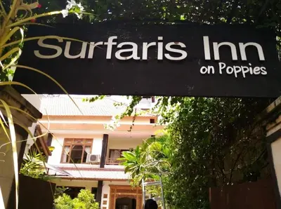 a sign that reads nutrients inn on properties in front of a building at Cempaka Apartment Surfaris Inn in Legian