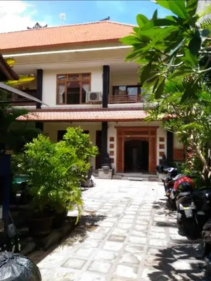 a house with a pathway in front of it at Cempaka Apartment Surfaris Inn in Legian