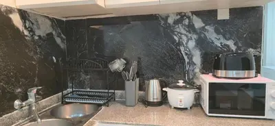 a kitchen counter with a sink and a microwave at The Palmana Tropical Garden Jayakarta Residence 36 in Seminyak
